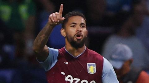 Douglas Luiz celebrates