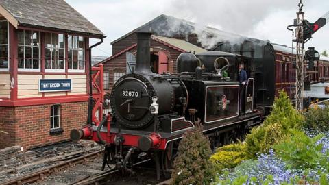 A steam train at Tenterden Town station