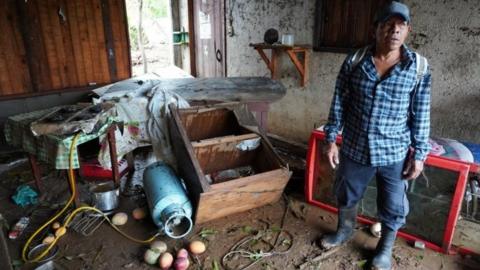 A man stands at his house damaged in the aftermath of Hurricane Agatha, in San Isidro del Palmar, Oaxaca state, Mexico, May 31, 2022.