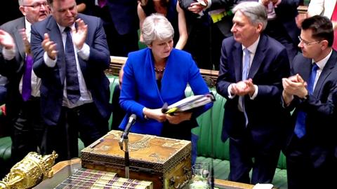 Theresa May looks back on her record at PMQs before she is cheered by colleagues as she leaves the chamber.