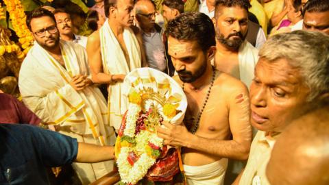 People of Malayali community wait for the temple doors to open at Makara Vilakku Mahotsavam at Ayyappa temple in Rasta Peth, on January 14, 2018 in Pune,