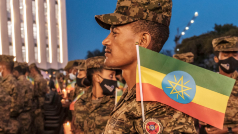 A member of the Ethiopian Federal Forces holds a candle during a memorial service for the victims of the Tigray conflict organized by the city administration, in Addis Ababa, Ethiopia, on November 3, 2021