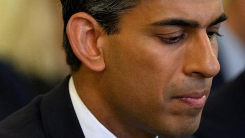 Britain's Chancellor of the Exchequer Rishi Sunak (R) reacts as Britain's Prime Minister speaks during a Cabinet meeting at 10 Downing Street, in London, on June 7, 2022. -