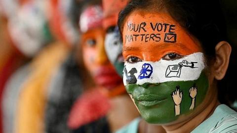 College students with painted faces spread awareness for first generation voters during an election campaign ahead of India's upcoming national election.