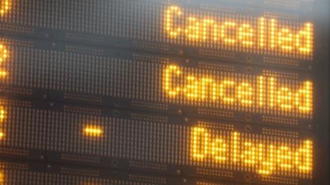 A departures board displaying cancelled and delayed trains