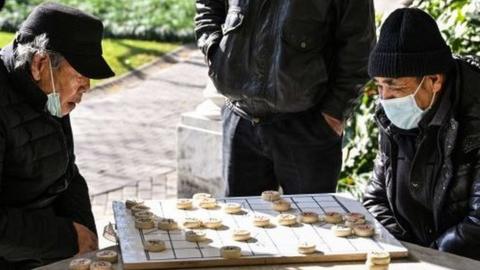 Men play Chinese chess in a park in the Jing'an district in Shanghai