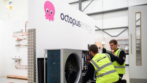 Engineers install a heat pump at the Octopus Energy training facility in Slough, England.