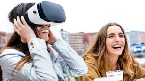 Woman with a VR headset on, drinking beer