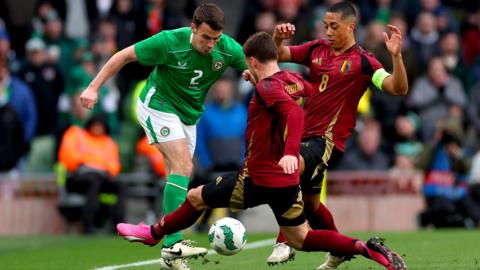 Seamus Coleman is tackled by Olivier Deman and Youri Tielemans