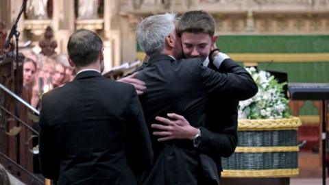 Dad David Webber hugging his son Charlie Webber