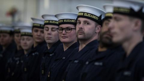 Members of the ship's company take part in a technical rehearsal in the hanger of the UK's latest aircraft carrier HMS Queen Elizabeth