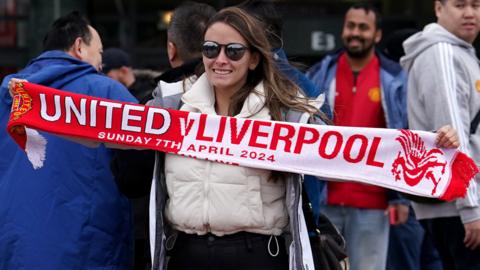 A fan outside the ground before the United-Liverpool fixture