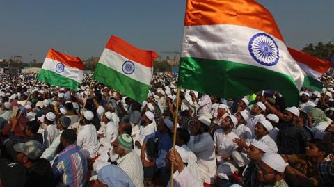 Demonstrators wave Indian national flags during a protest against the Citizenship Amendment Act (CAA) and National Register of Citizens (NRC) and National Population Register (NRP) in Mumbai, India on 15 February 2020