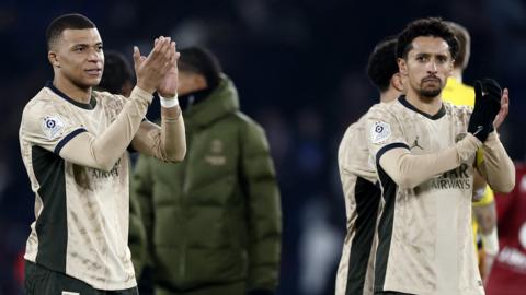 Kylian Mbappe and Marquinhos applaud fans after the match