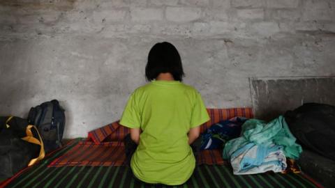 Myanmarese policewoman, who fled Myanmar and crossed illegally to India, rests in a temporary shelter at an undisclosed location in India's northeastern state of Mizoram on March 13, 2021.