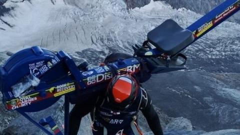 Matthew Disney scales a mountain with a rowing machine