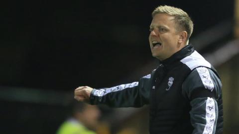 Interim Lincoln City boss Tom Shaw shouts instructions to his players from the sideline