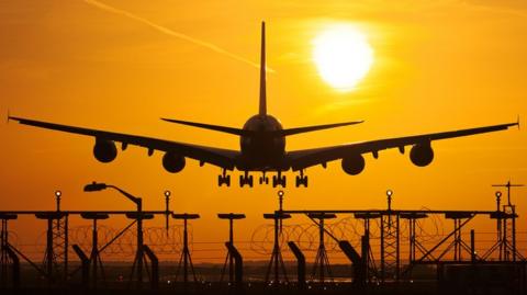 airplane-landing-at-sunset