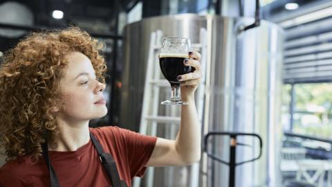 Woman working in craft brewery