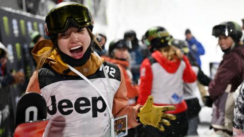 Freestyle skiier Zoe Atkin runs to celebrate with family and friends after winning gold during the 2023 X Games Women's Ski SuperPipe finals in Aspen, Colorado