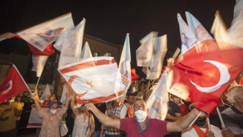 Supporters of Ersin Tatar celebrate his victory in the northern part of the divided capital Nicosia