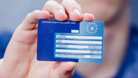 Hand holding a European Health Insurance Card