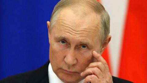 Vladimir Putin with hand to face