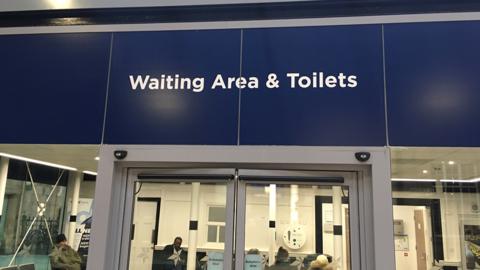 Toilets and waiting room sign
