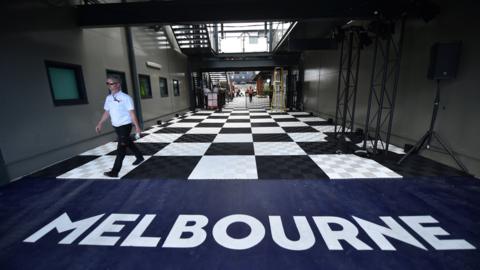 A man walking down a corridor at Albert Park in Melbourne