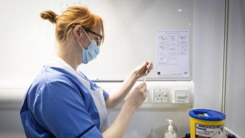 Nurse prepares coronavirus vaccine