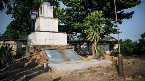 A man stands at the grave of the Banunu traditional chiefs in the western village of Yumbi, in the Democratic Republic of the Congo, on January 28, 2019