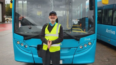 Driver Domingos Correia stood by an Arriva bus