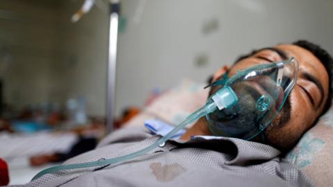 A man infected with cholera lies on a bed at a cholera treatment centre in Sanaa, Yemen (15 May 2017)