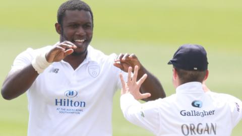 Hampshire's Keith Barker celebrates a wicket with team-mate Felix Organ.