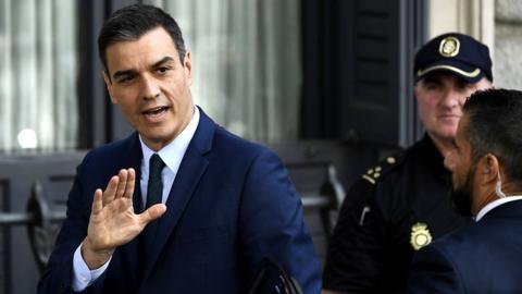 Spanish caretaker Prime Minister Pedro Sanchez waves as he arrives for the parliamentary investiture debate and vote to elect a premier, 25 July 2019