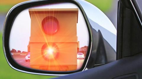 Speed camera flashing in rear view mirror