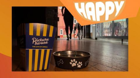A popcorn box and dog bowl