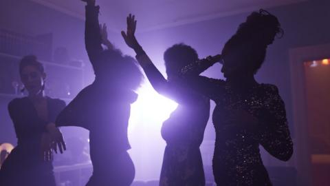 Girls dancing at a house party