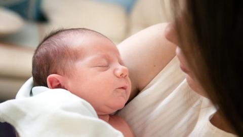 Newborn baby with its mother