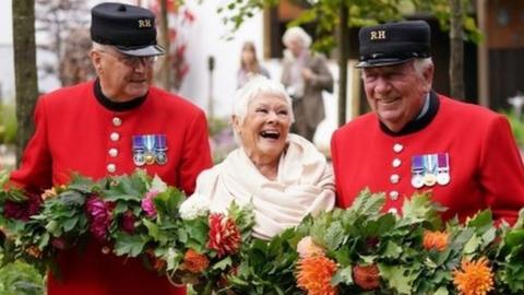 Dame Judi Dench with Chelsea Pensioners during the RHS Chelsea Flower Show