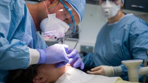 Dentist treating patient