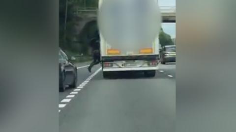 Person jumping from lorry