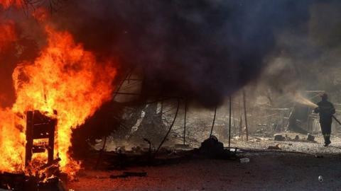 A fireman fights flames in the Moria refugees camp on the island of Lesbos, Greece, 10 September 2020