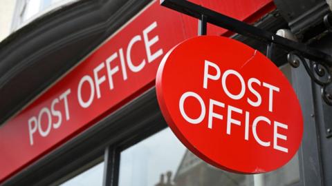 A sign for a Post Office