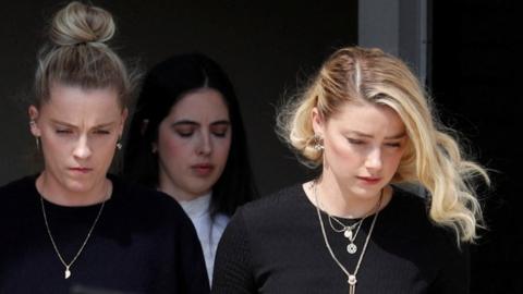 Amber Heard leaves Fairfax County Circuit Courthouse after the jury announced split verdicts in favor of both her ex-husband Johnny Depp and Heard on their claim and counter-claim in the Depp v. Heard civil defamation trial