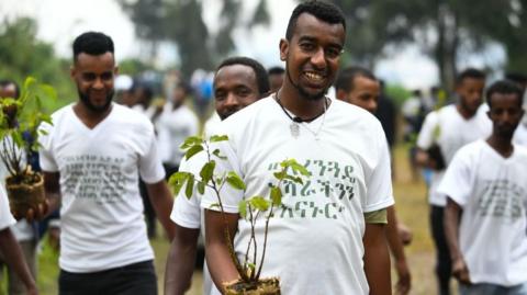 Men with saplings