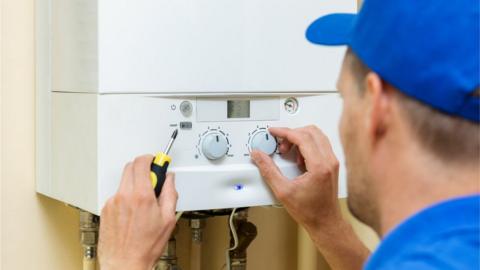 Plumber working on gas boiler