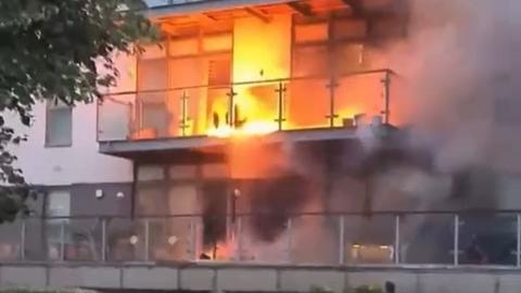 Flames engulfing an apartment balcony