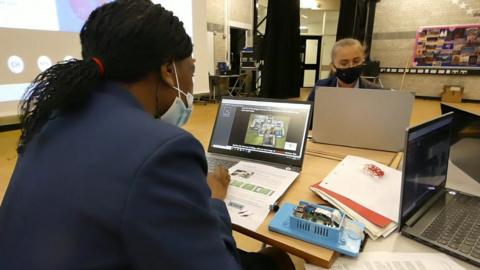 Two girls using computers to take part in the CyberFirst Girl's Competition