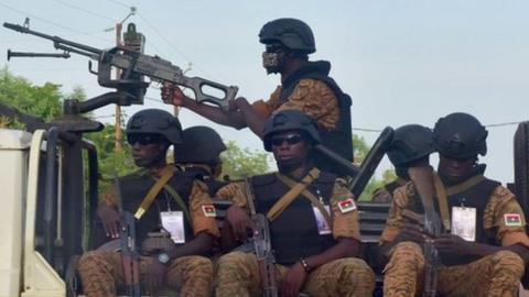 Burkinabe gendarmes sitting on their vehicle in the city of Ouhigouya in the north of the country in October 2018